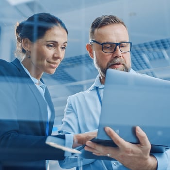 Ransomware data recovery: 2 persons behind laptop working together on custom build recovery tools